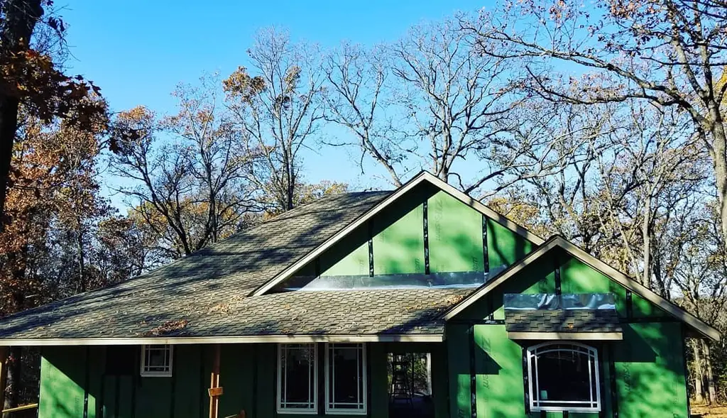 New construction roof with dark architectural shingle over fresh sheathing
